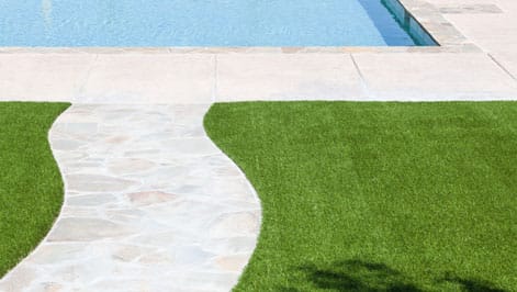 Clear suburban path leading to a clean, sparkling swimming pool.