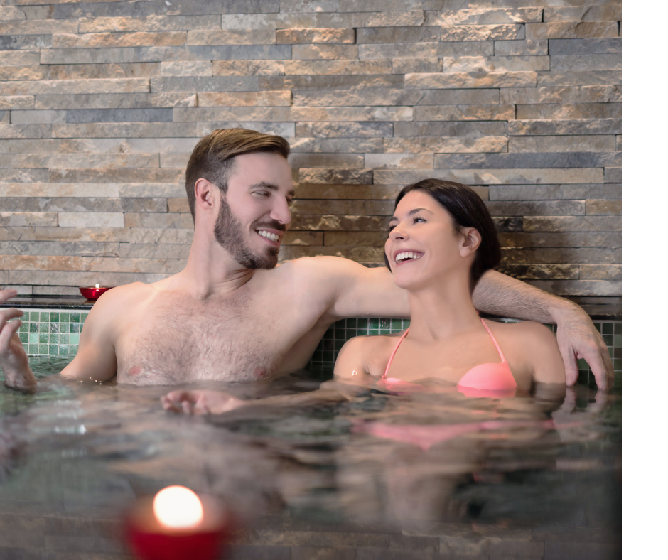 Couple in Hot Tub Laughing Photo of a young couple talking and laughing in a hot tub.