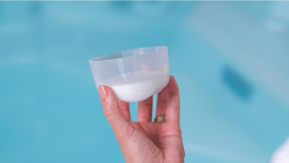TruDose™ cap filled about one-quarter full — generic measurement for hot tub supporting chemicals.