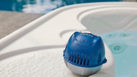 FROG® @ease® Target system placed beside a clear hot tub — simple, effective water care solution.